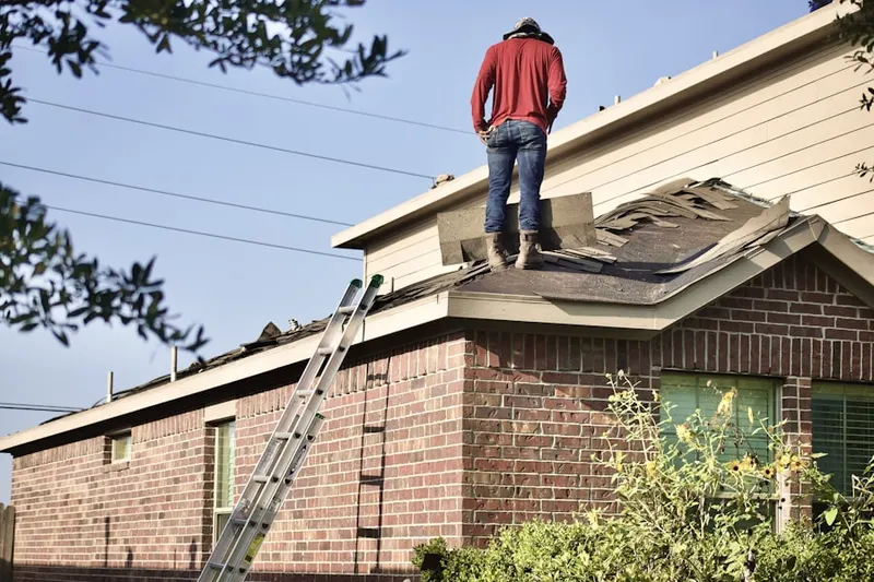 Professional roofer working on a residential roof in San Leanna